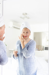 Woman applying anti-age cream