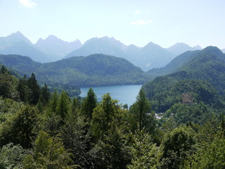 Obraz premium simple mountain landscape with a lake partly hidden by dense forest 
