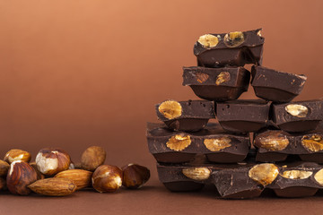 Stack of dark chocolate pieces with roasted almonds