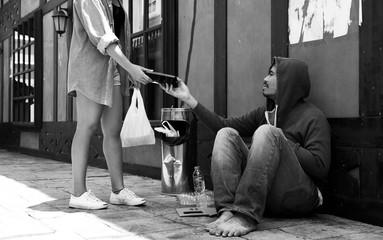 A young women give food for homeless man,Homeless man happy with food from humanitarian woman