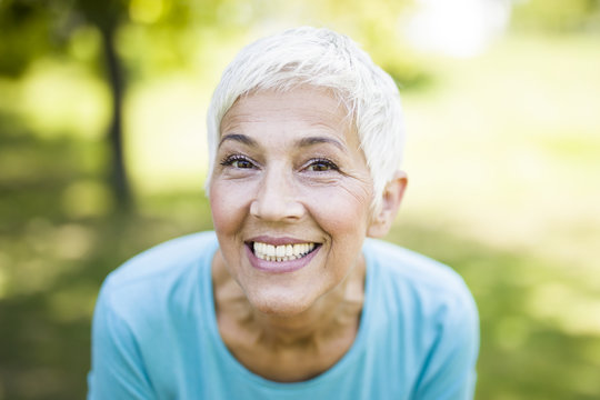 Portrait of a smiling sporty senior woman in a park