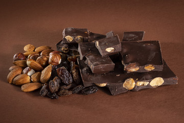 Stack of dark chocolate pieces with roasted almonds and raisins