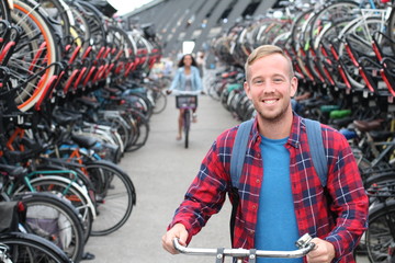 Joyful blonde man in bicycle 3D parking lot