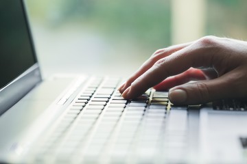 Woman's Hand Typing on a Laptop
