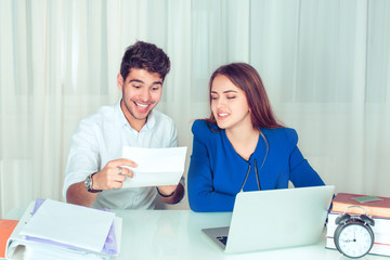 Cheerful man receiving note in office