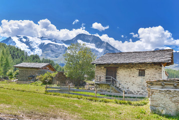 Fototapeta na wymiar village in the valley next to alpine glacier in summer