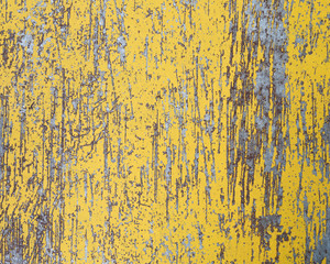 Worn yellow paint on metal sheet texture background
