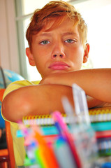 school boy depressed while doing homework