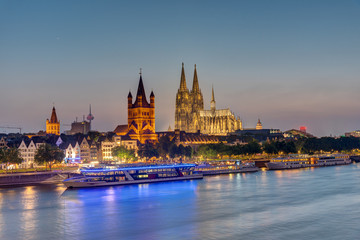 The famous skyline of Cologne with the river Rhine and the cathedral at dusk	