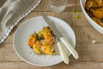 Stuffed with ricotta and cheese baked zucchini and pumpkin flowers served with a glass of mineral water. Rutik style.
