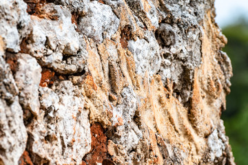 Close up on a textured old stone mud wall of natural stones in the countryside