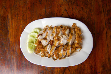 The fried chicken in a dish with cucumber,  eat with rice as foods that are beneficial to the body