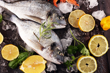 Delicious fresh fish. Fish with aromatic herbs, spices and vegetables - healthy food, diet or cooking concept.