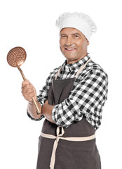 Naklejka premium Mature male chef holding skimmer on white background