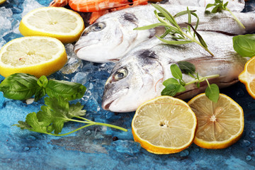 Delicious fresh fish. Fish with aromatic herbs, spices and vegetables - healthy food, diet or cooking concept.