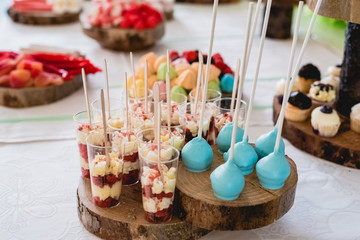 Desserts and wedding cake with very sweet cupcakes at an event.