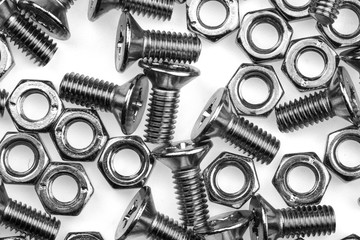 pile of a bolts and screws on white background.