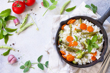 Healthy food: Fried rice with vegetables. Prepared and served in a cast-iron frying pan. Diet menu....