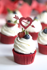 Colorful cupcakes with buttercream and fresh berries