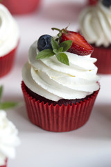 Colorful cupcakes with buttercream and fresh berries