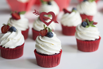 Colorful cupcakes with buttercream and fresh berries
