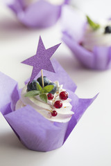 Colorful cupcakes with buttercream and fresh berries