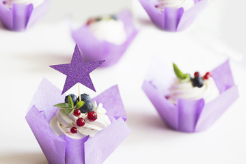 Colorful cupcakes with buttercream and fresh berries