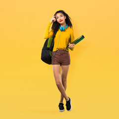 Full body of Teenager student girl with curly hair having doubts and with confuse face expression...