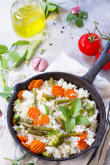 Healthy food: Fried rice with vegetables. Prepared and served in a cast-iron frying pan. Diet menu. Copy space.