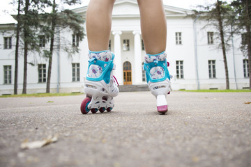 feet on roller skates on the pavement