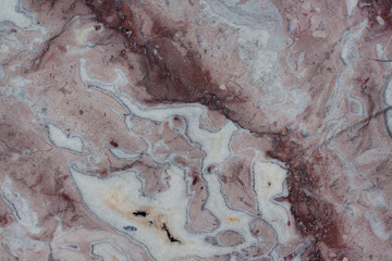 Reddish-brown base with dark and gray spots. Classic travertine texture. Used as a background.