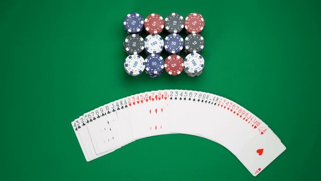 Poker player fanning playing cards across the table, gambling, dealer shuffling. Poker background