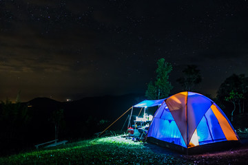 camping tent in the night mountain under a starry sky