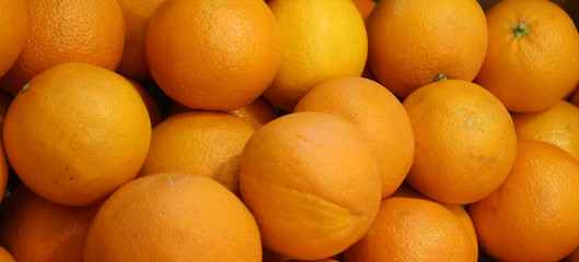 Close up of Ripe orange citrus on the counter market stall. Fresh fruit texture. 