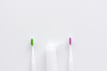 Clean teeth. Toothbrushes and tooth paste on white background top view space for text