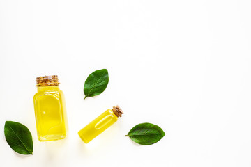 Tea tree essential oil near tea tree leaves on white background top view copy space