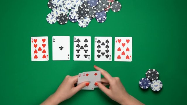 Poker player folding cards, weak hand, unsuccessful game, money loss. Top view. Gambling, card games