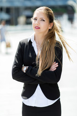 Confident young female manager outdoor in a modern urban setting