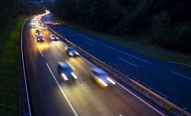 View of traffic car lights on a busy highway at night.