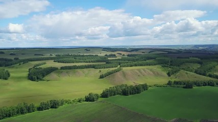 Drone footage of the filelds and hills with bushes