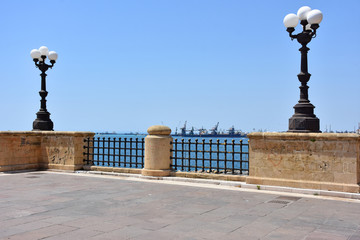 Italy, Puglia region, Taranto, street lamps for street lighting in the city and seafront.