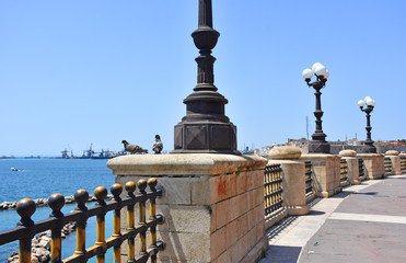 Fototapeta na wymiar Italy, Puglia region, Taranto, street lamps for street lighting in the city and seafront.