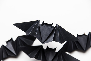 Halloween origami paper dracula bats on a white background