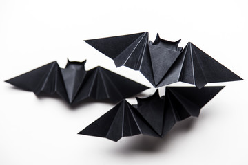 Halloween origami paper dracula bats on a white background