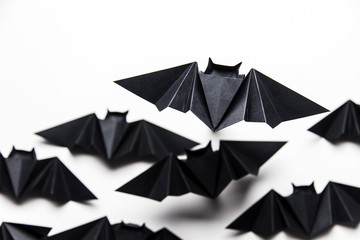 Halloween origami paper dracula bats on a white background