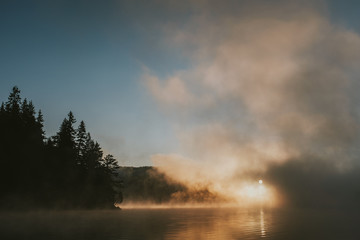 Sunrise on foggy lake