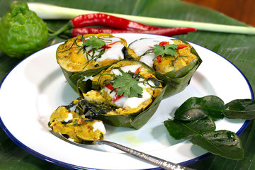 Steamed fish with curry paste (Thai language Hor mok) in banana leaf bowl Thai food