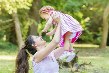 Obraz premium Happy Mother with her Baby Girl in the Summer Park .Mother and Daughter .Happy Family, Mother with Little Child