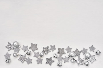 Christmas greeting card. Christmas silver decoration on white background. Top view, copy space