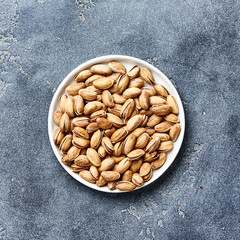 Salted Pistachios nuts with copy space. Top view of snacks.